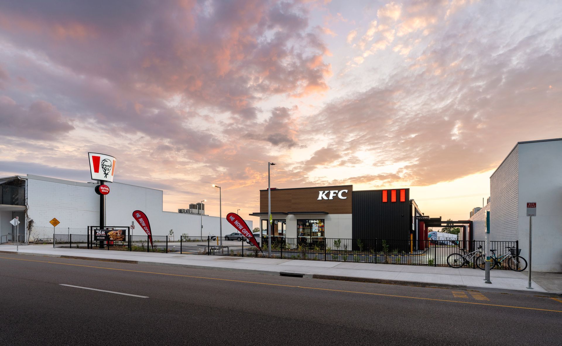 Modern KFC building with lavender sunset in the background