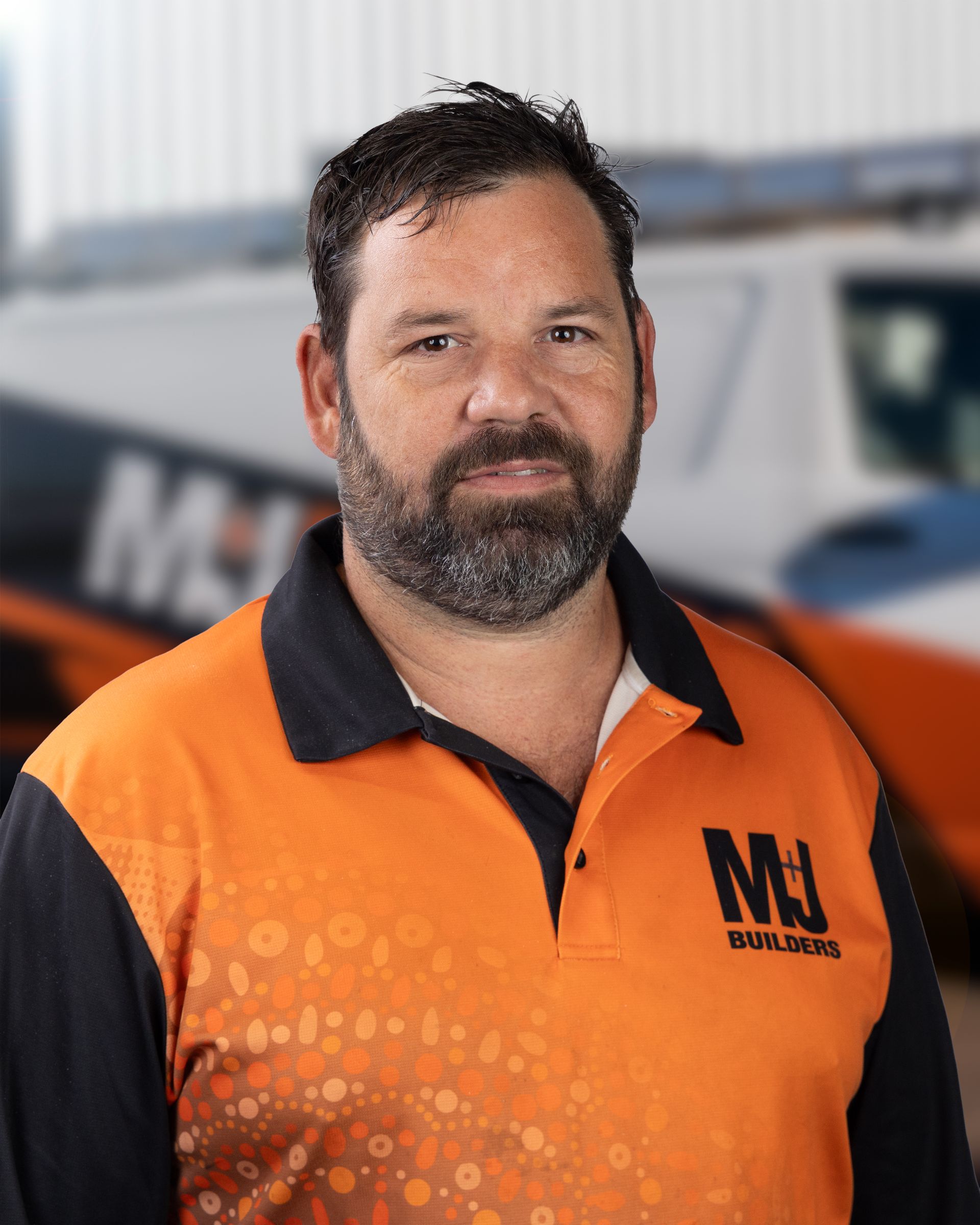 Man in orange polo shirt with