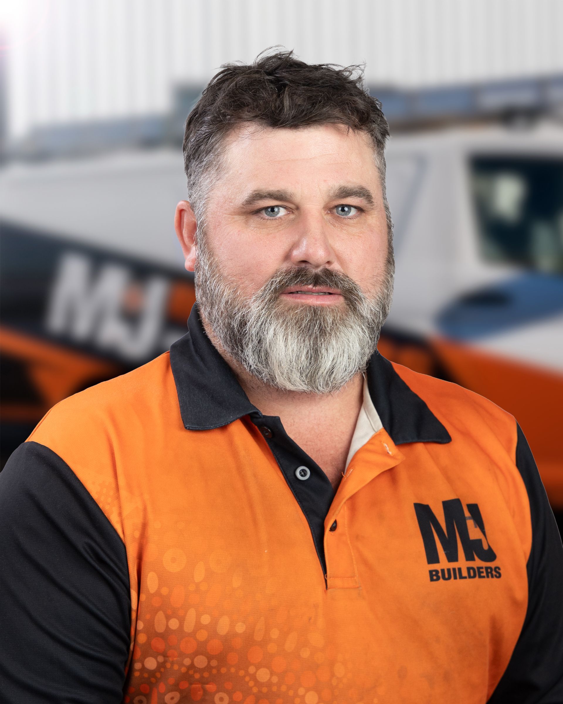 Man in orange and black polo shirt,