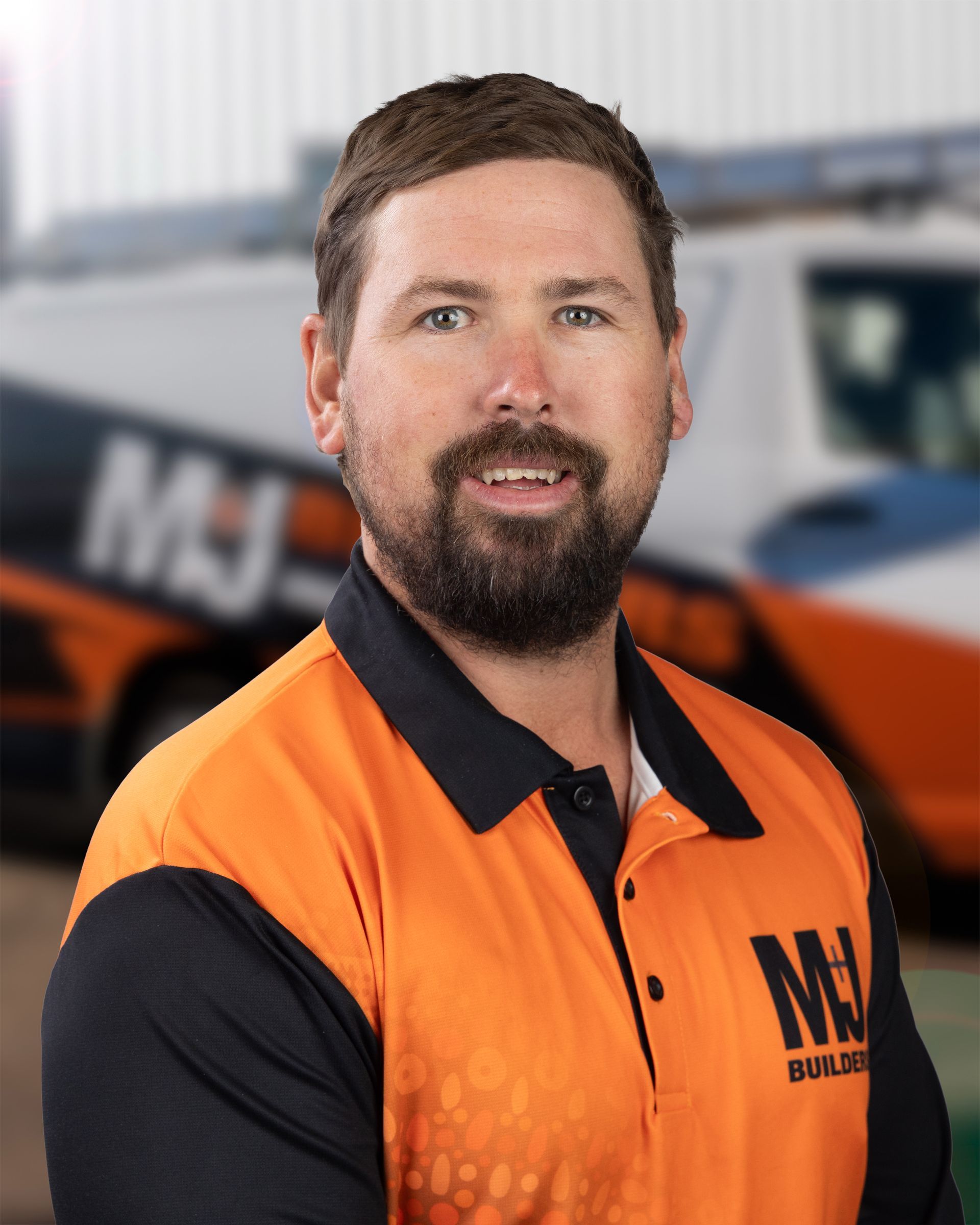 Man in orange and black polo shirt with