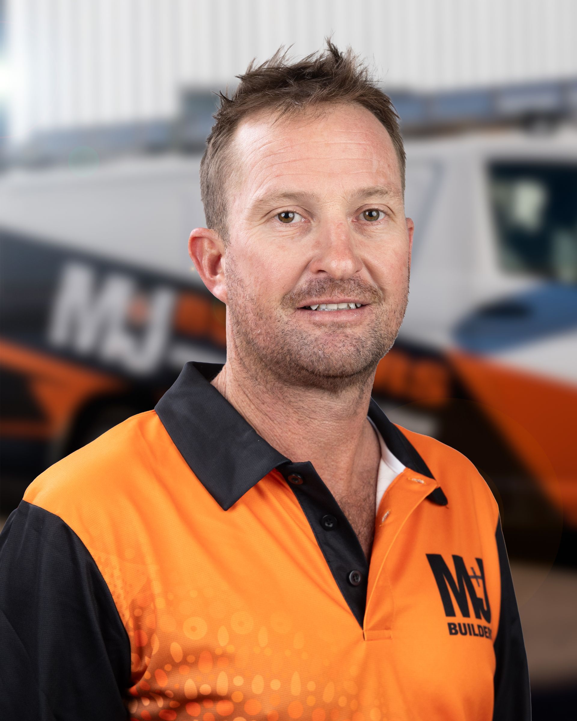 Man in orange polo shirt with