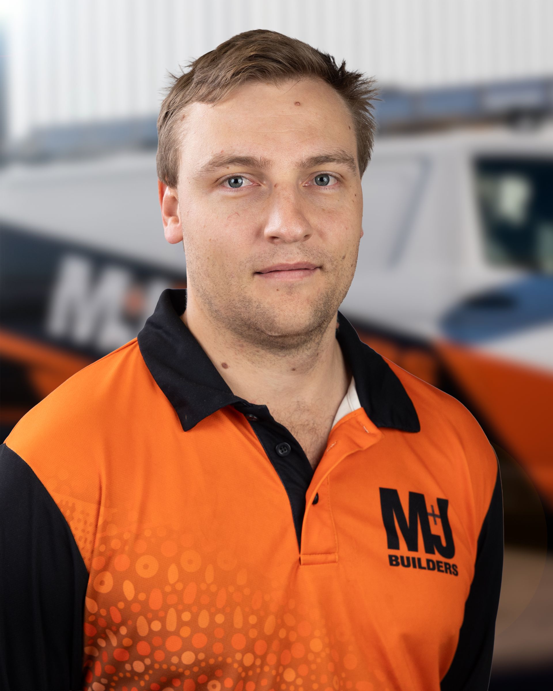 Man in orange and black polo shirt with