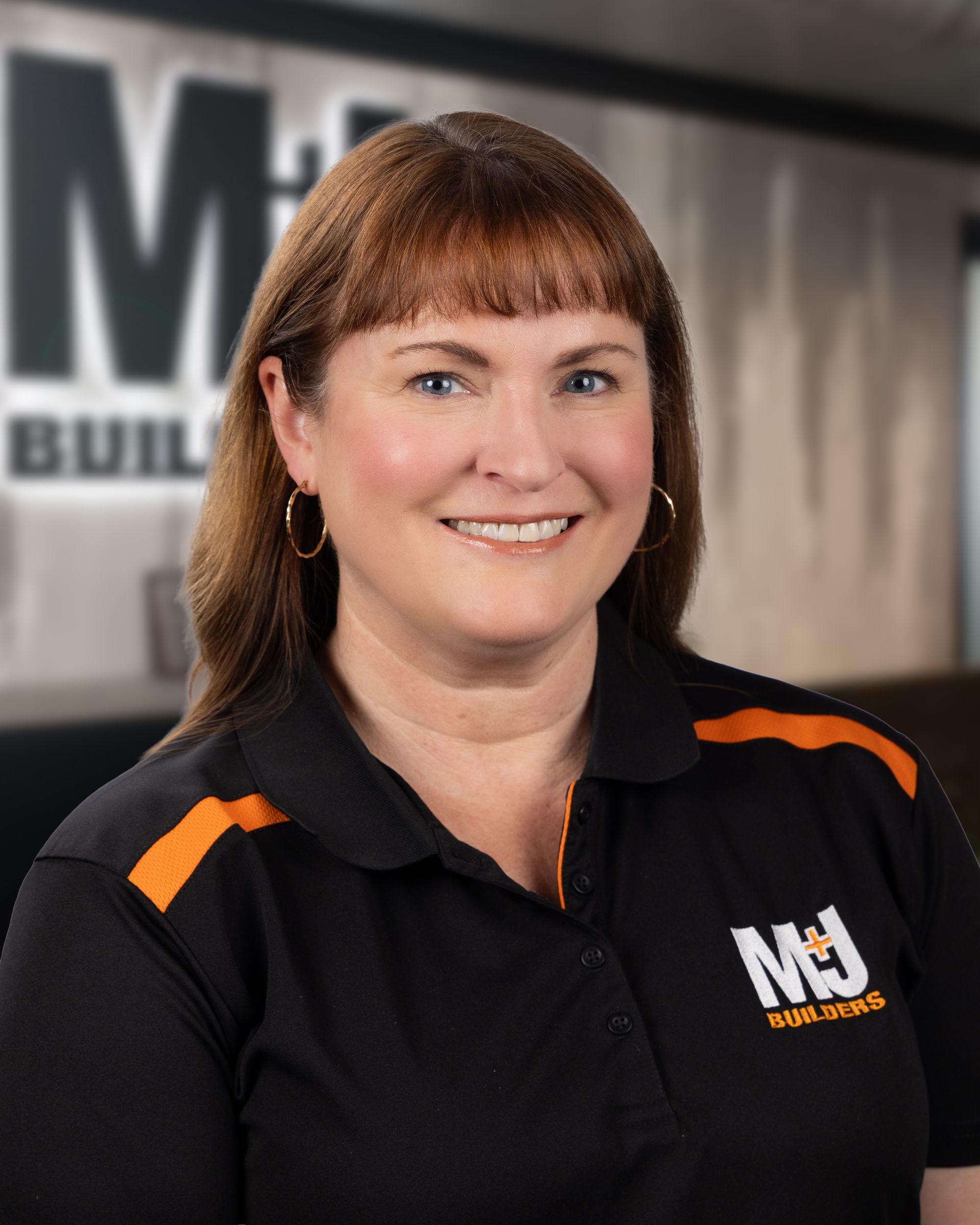 Silhouette of a woman, shoulder-up view. Short hair, gray silhouette on a gray background.