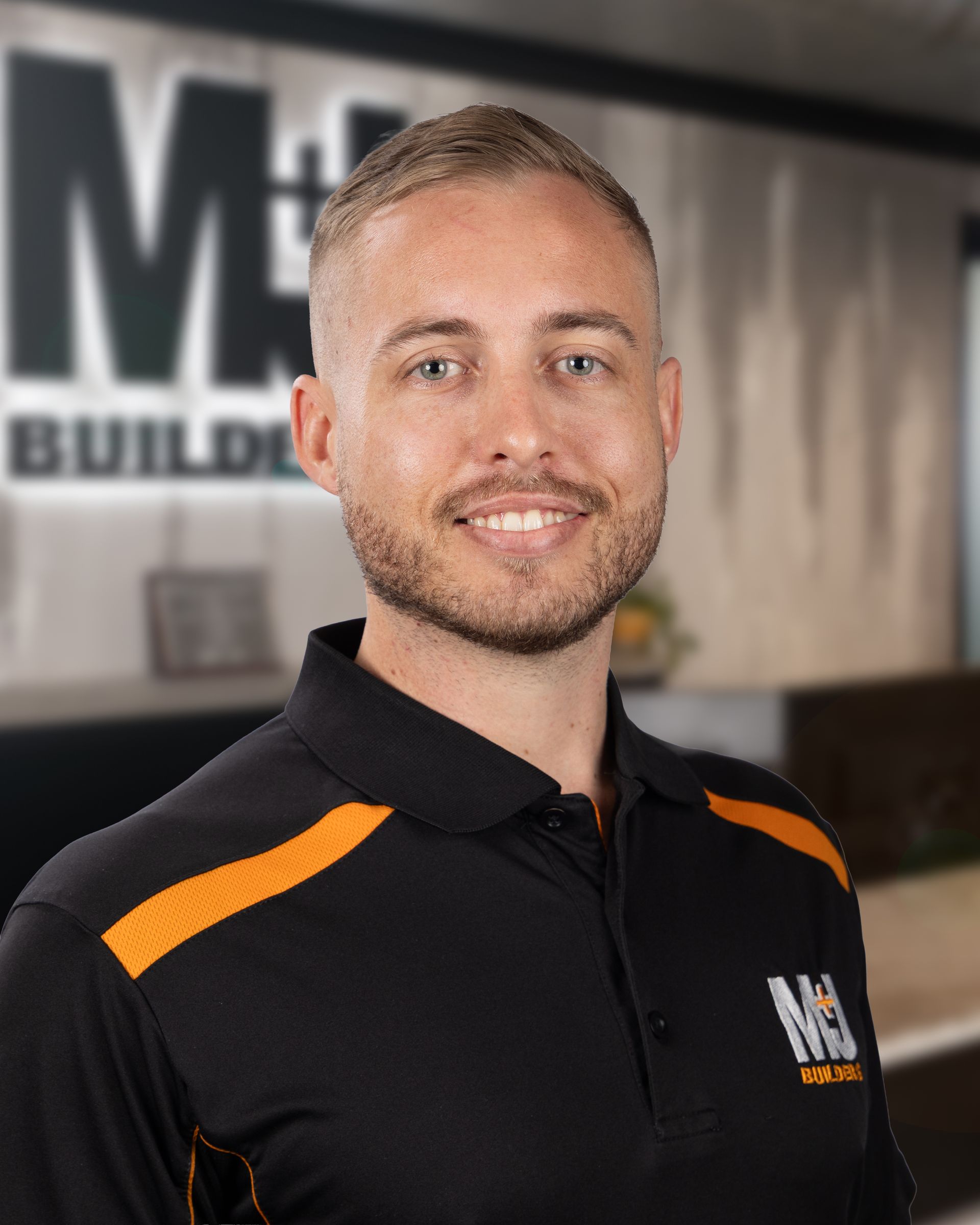 Man in black and orange polo shirt with