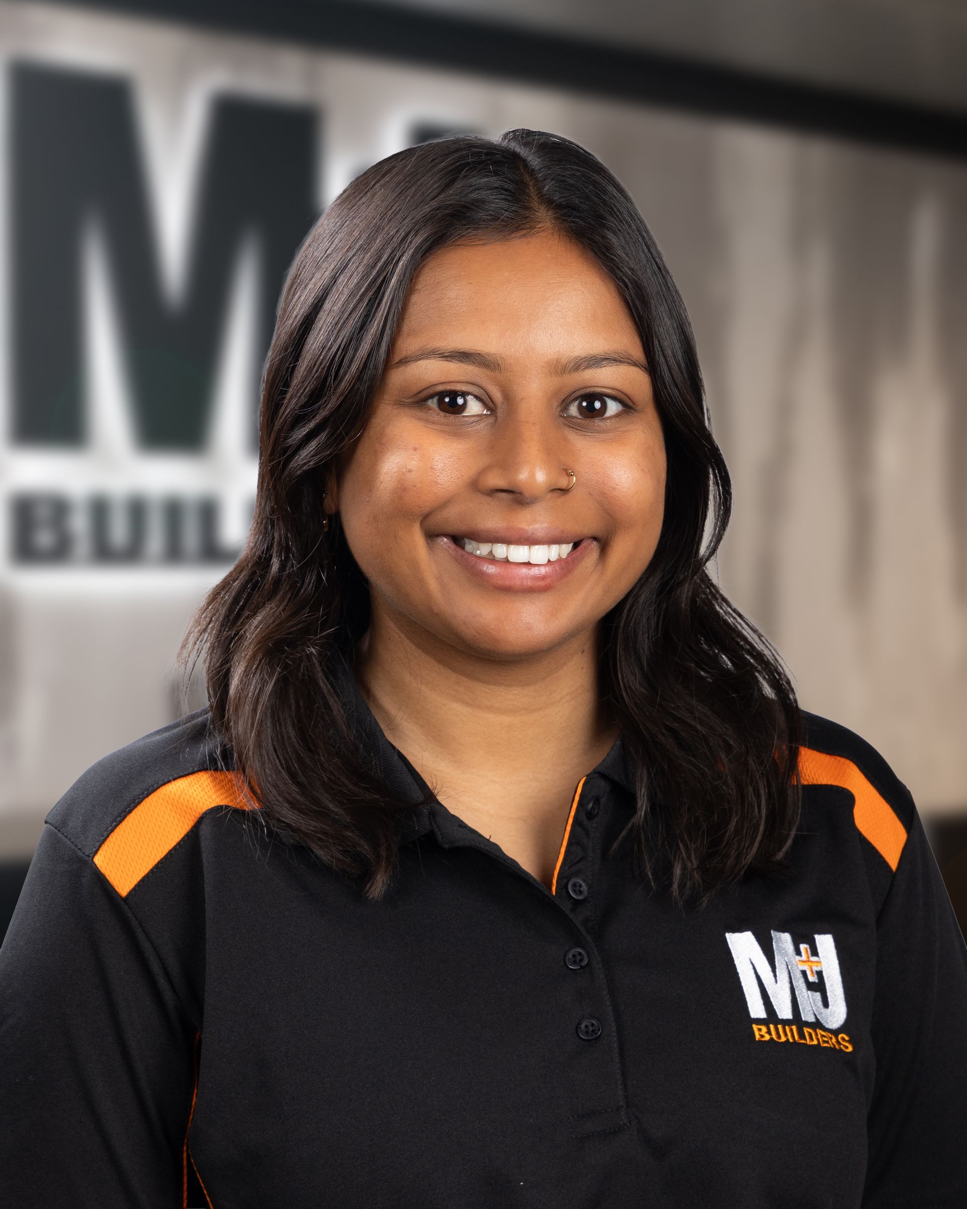 Silhouette of a woman, shoulder-up view. Short hair, gray silhouette on a gray background.