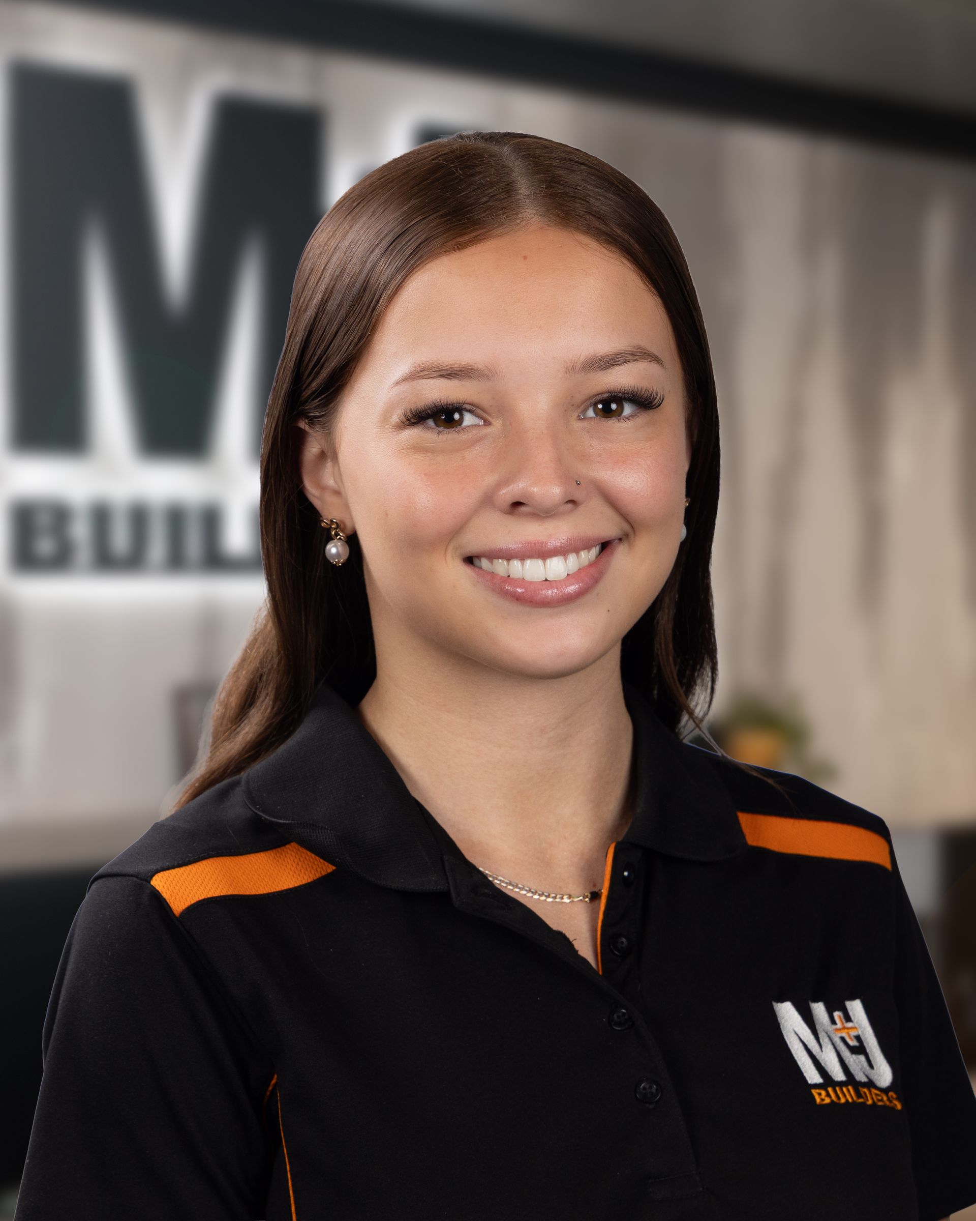 Smiling woman with curly hair in black shirt with