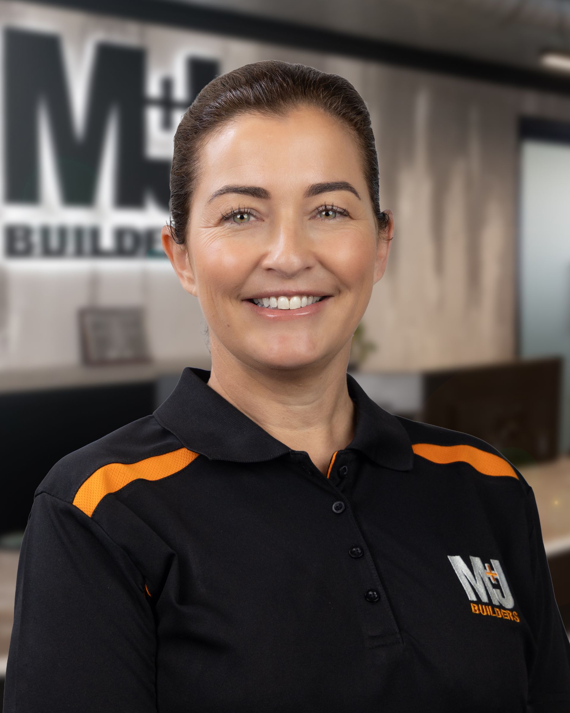 Woman with dark hair and black top smiles, likely for a clinic portrait.