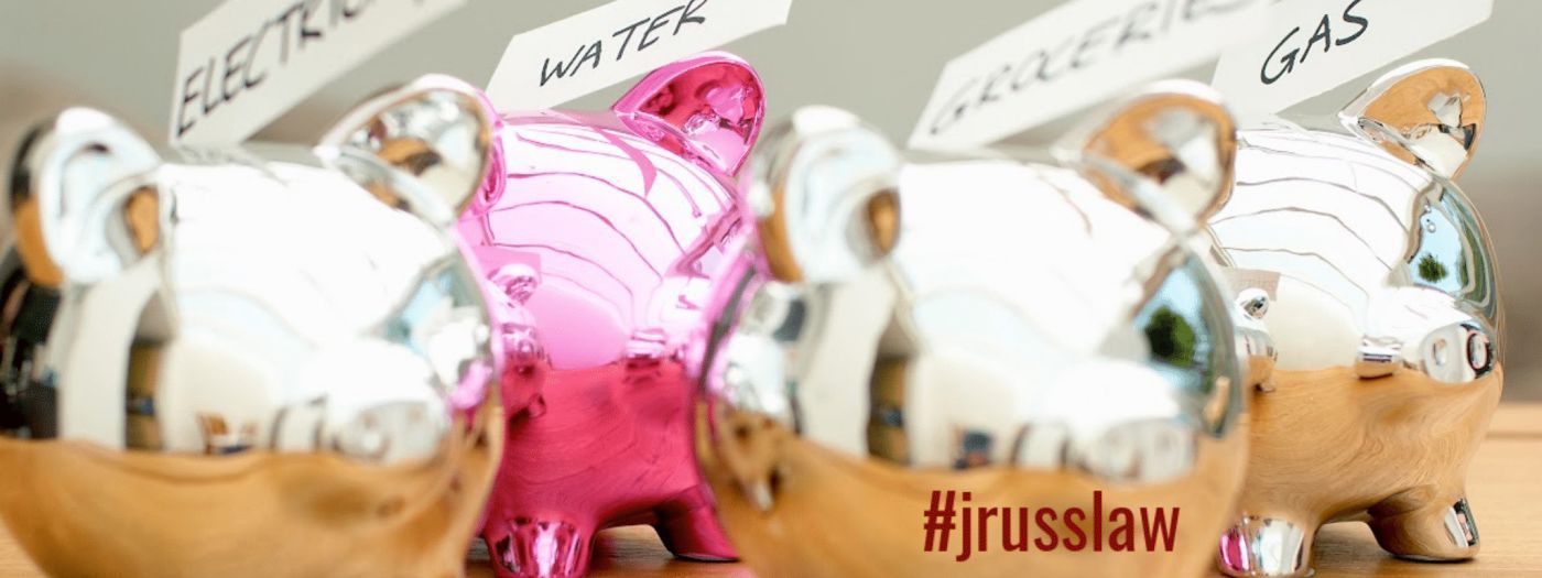 Three piggy banks are sitting next to each other on a table.