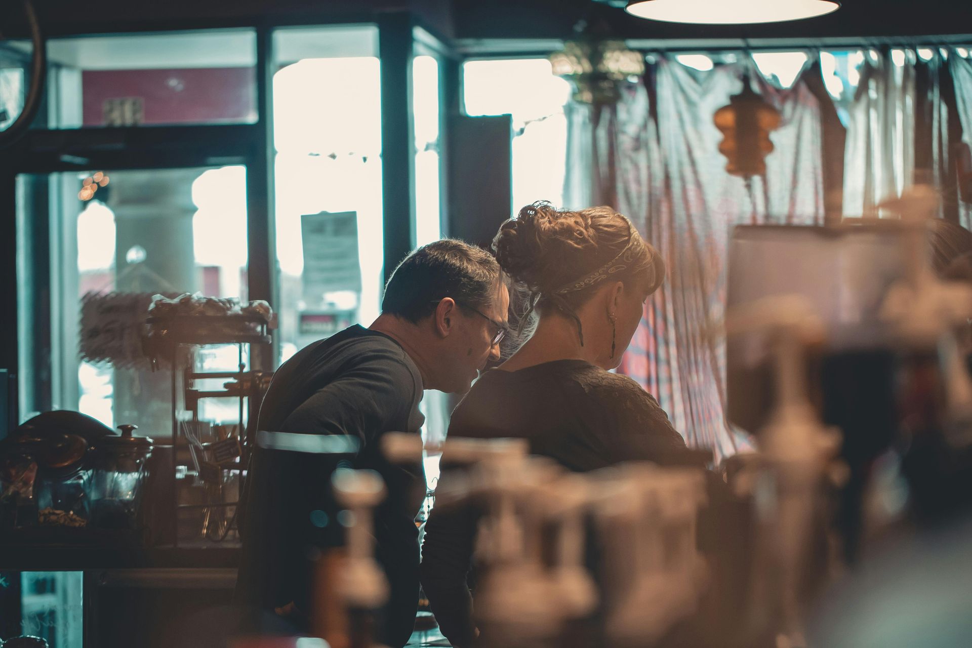 A man and a woman are sitting at a table in a restaurant.