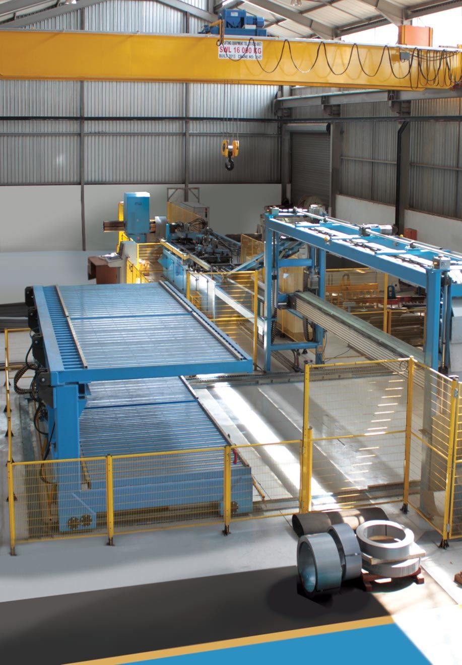 an aerial view of a factory with blue and yellow machinery