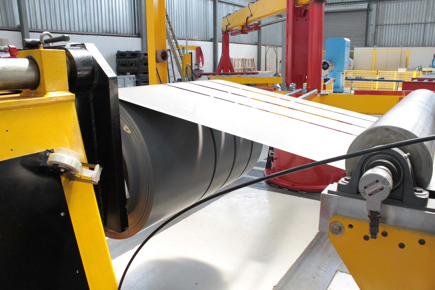 a machine is cutting a piece of metal in a factory .