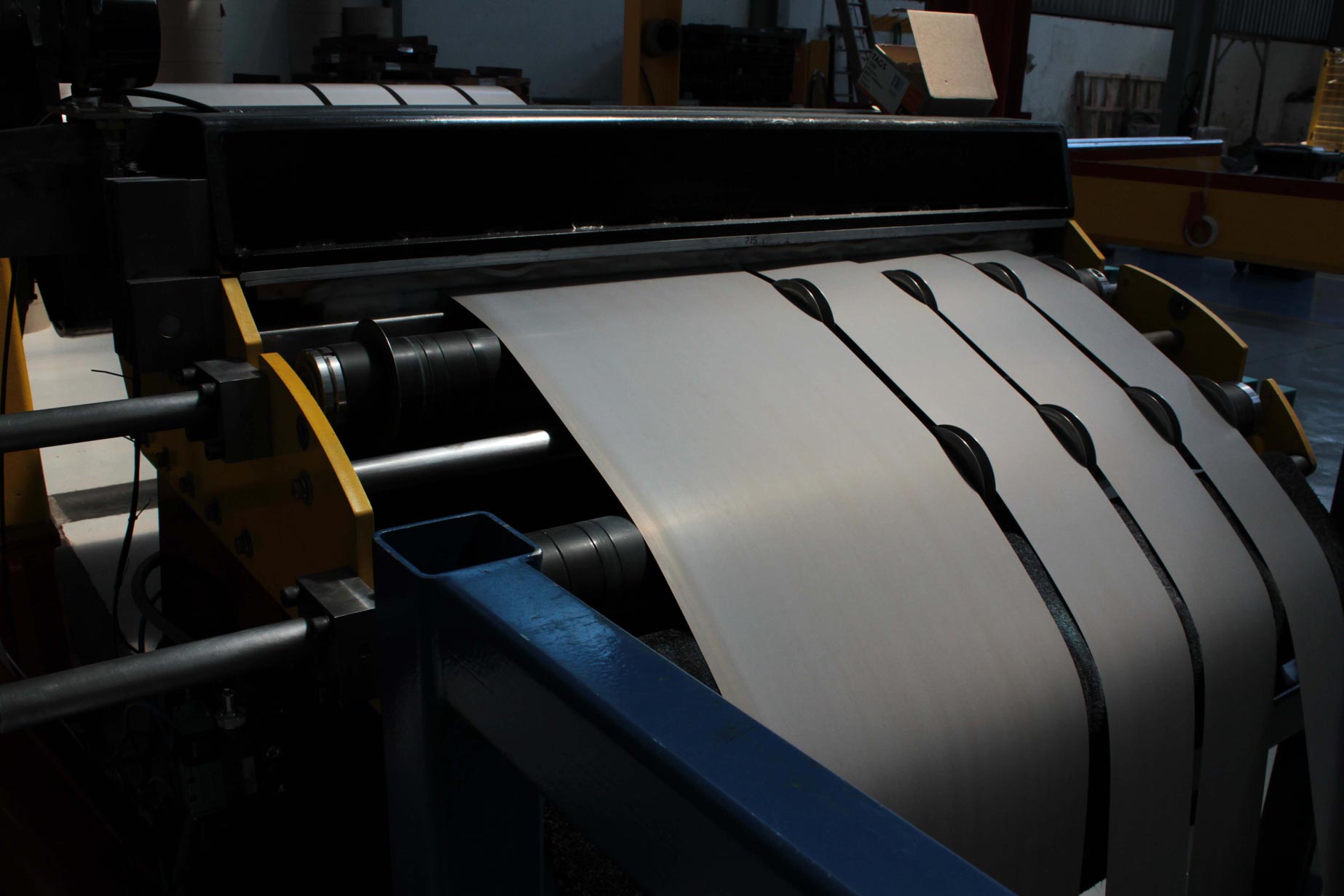 a machine is cutting a sheet of metal in a factory