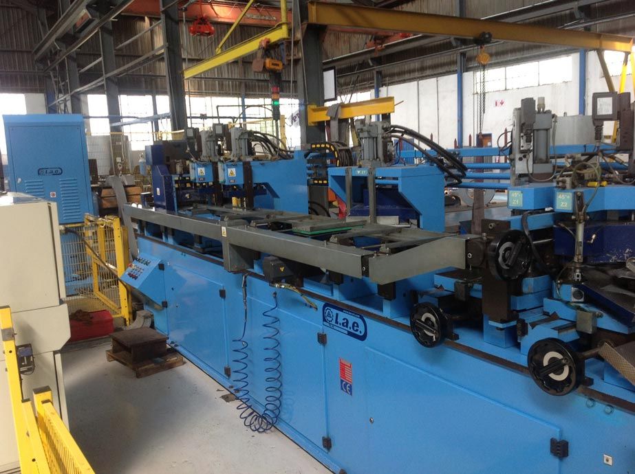 a large blue machine is sitting in a factory .