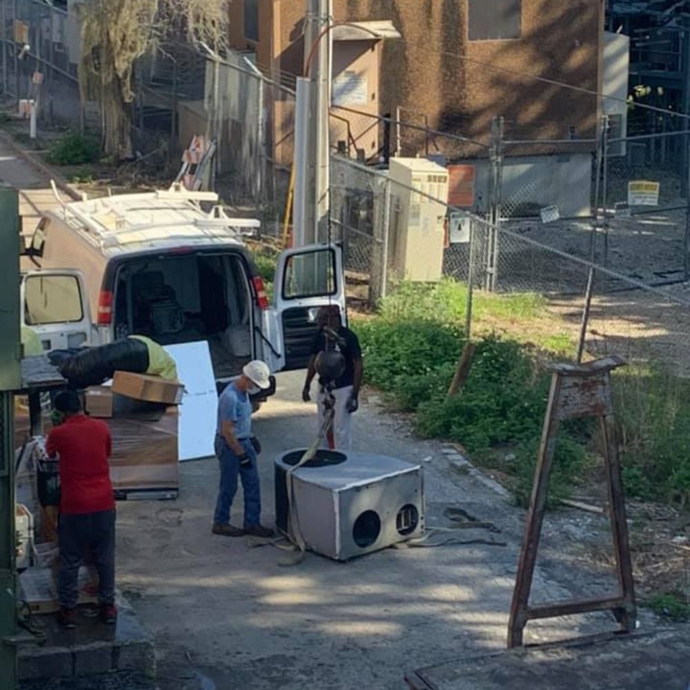 a man is standing next to a fridge in front of a van