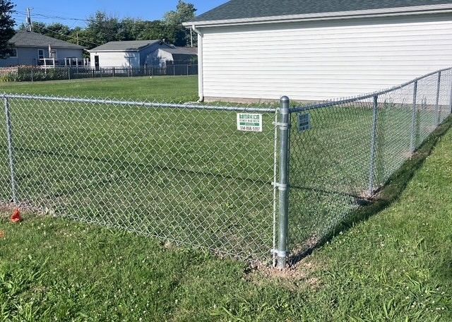 Galvanized chain link fence installation in backyard – affordable, durable fencing solution for homes in St. Louis MO.