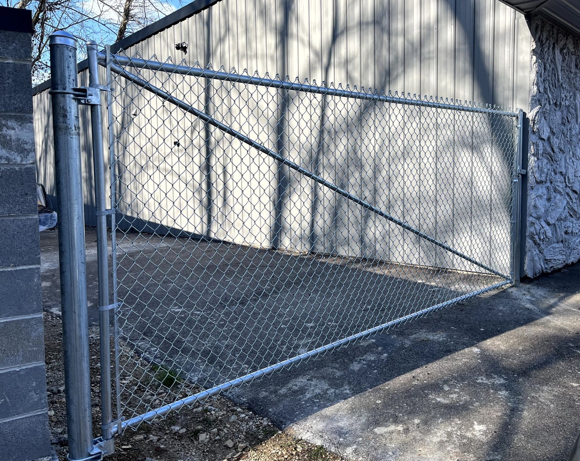 Commercial grade chain link single drive gate installation up to 16 feet wide by Makic Fence & Deck serving the St. Louis region