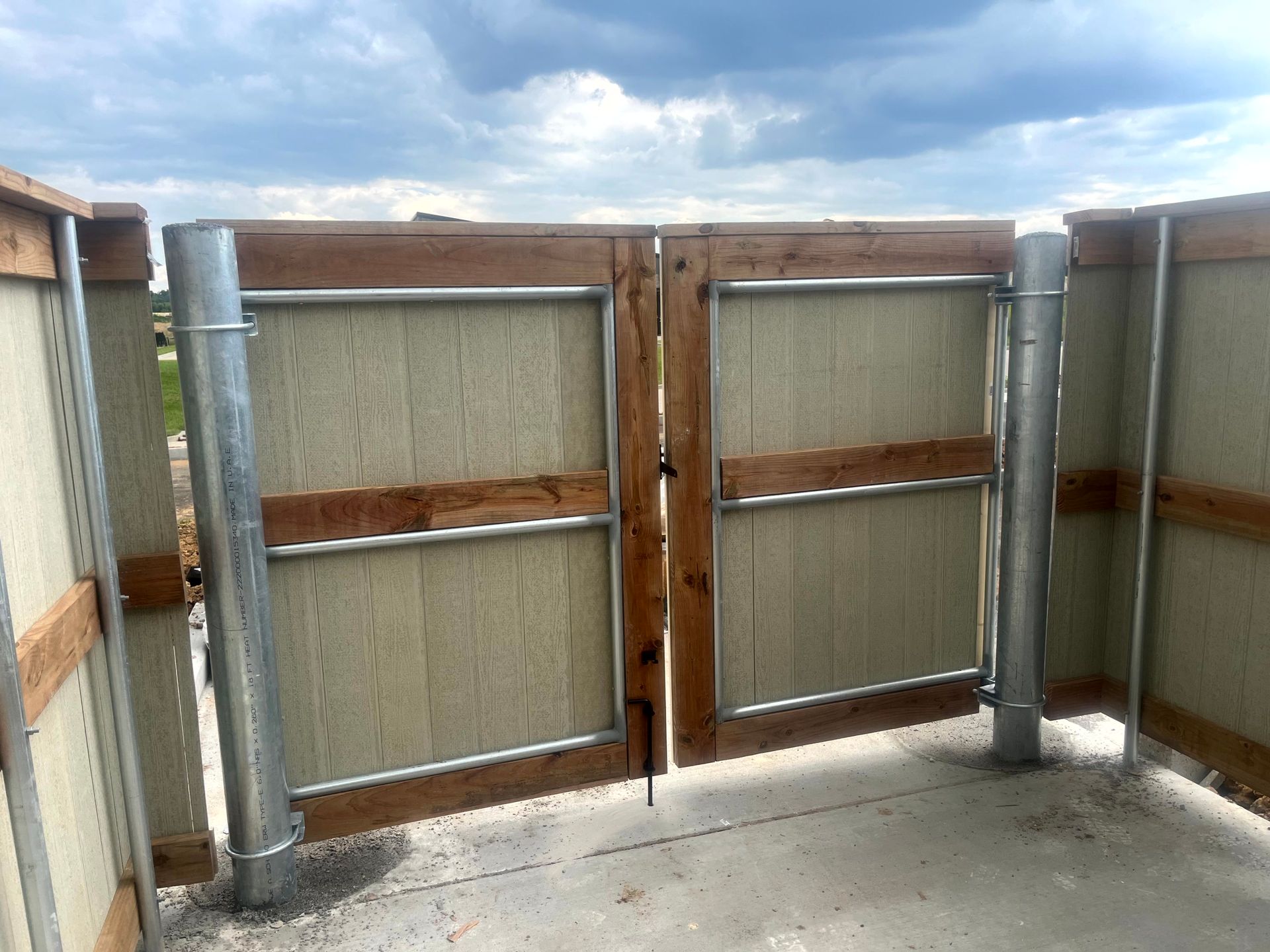 Commercial dumpster enclosure with double swing gates for restaurant waste area