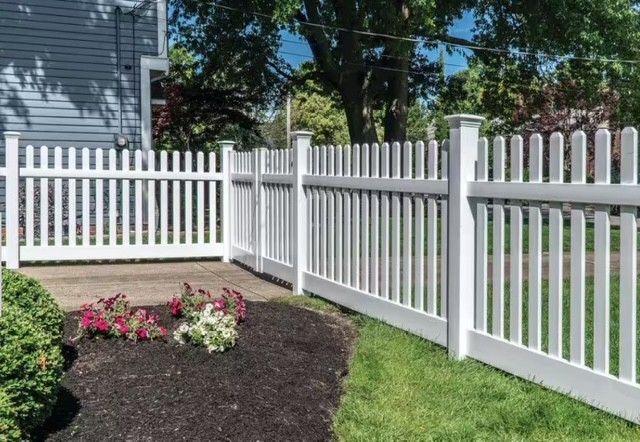 White vinyl picket fence installation in front yard – decorative and low-maintenance fencing for homes in St. Louis MO.