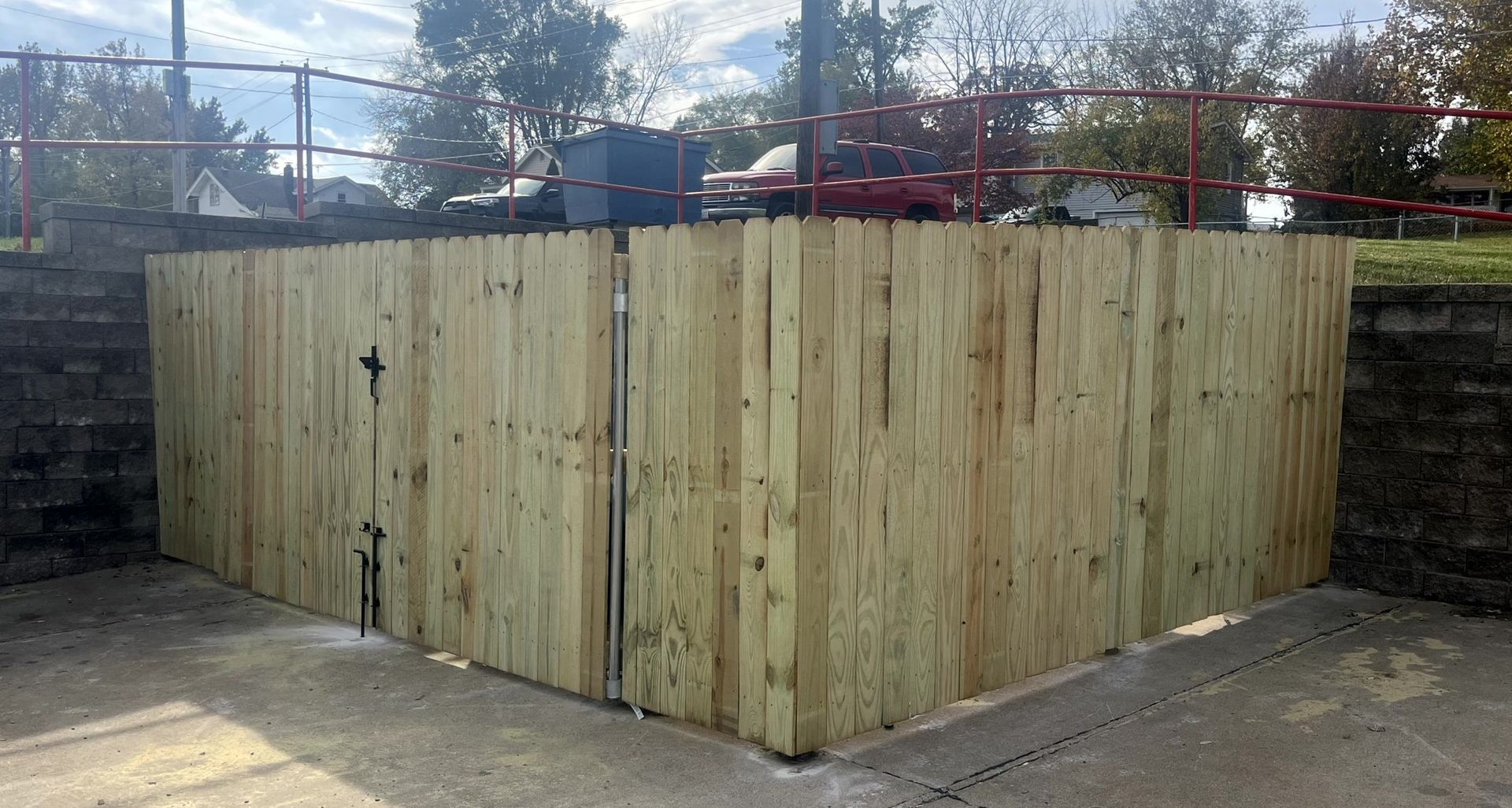Large commercial dumpster enclosure built for apartment complex trash area