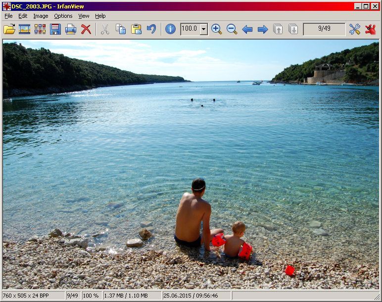 The Infranview software display shows an image of a man and a child are sitting on the beach near the water