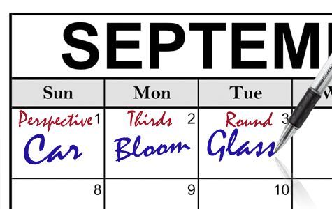 A pen is writing sets of words on a calendar for the month of September