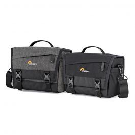 Two messenger camera bags are sitting next to each other on a white background.