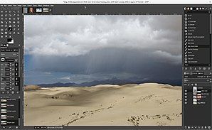 A computer screen running GIMP, shows a picture of a desert landscape.