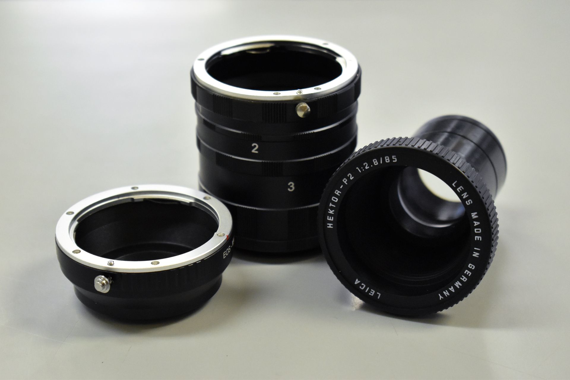 A stack of leica lens rings on a table