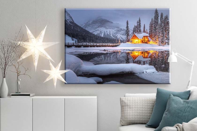 Canvas print on a wall with two people walking on the beach at sunset