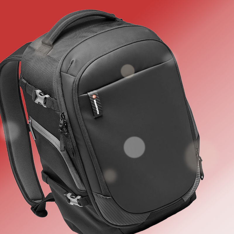 A black manfrotto backpack is on a pink background