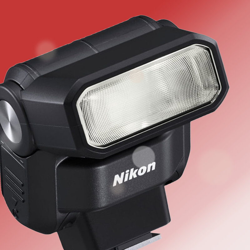 A close up of a nikon flash on a pink background