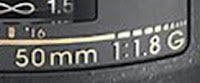 A close up of a camera lens that says 50mm 1 : 1.8g