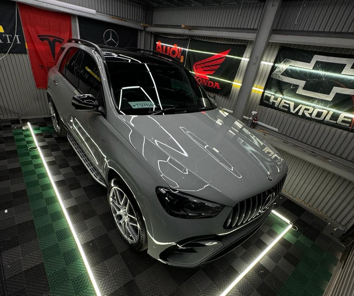 Mirror-like finish on a ceramic coated car under studio lighting