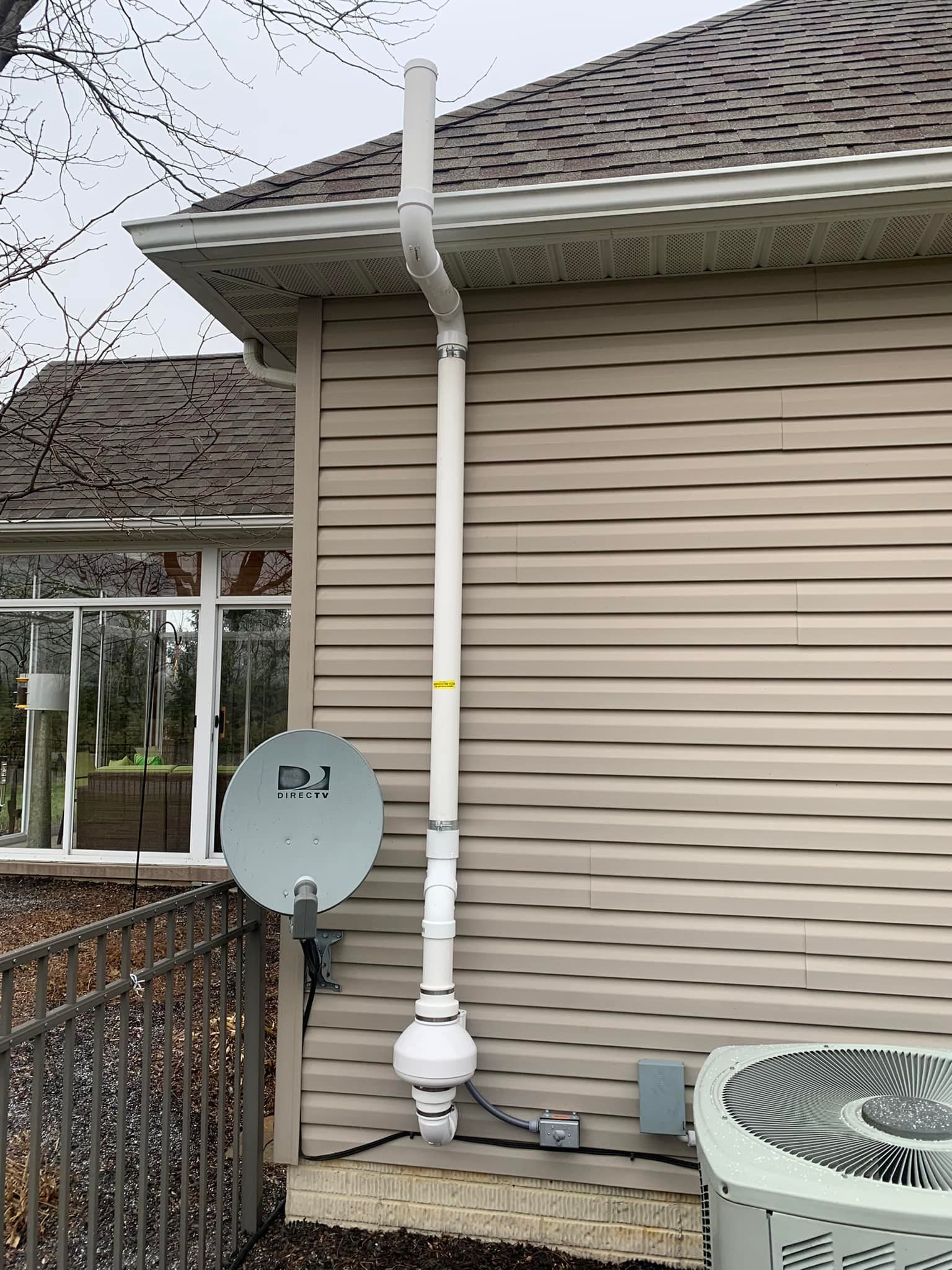 A house with a satellite dish on the side of it.