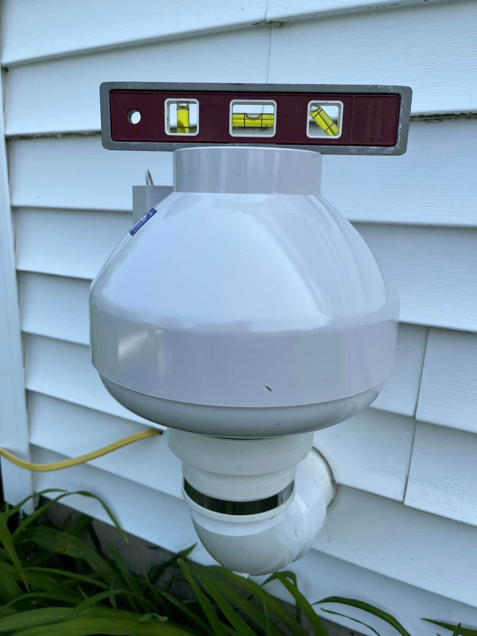 A level is sitting on top of a white object.