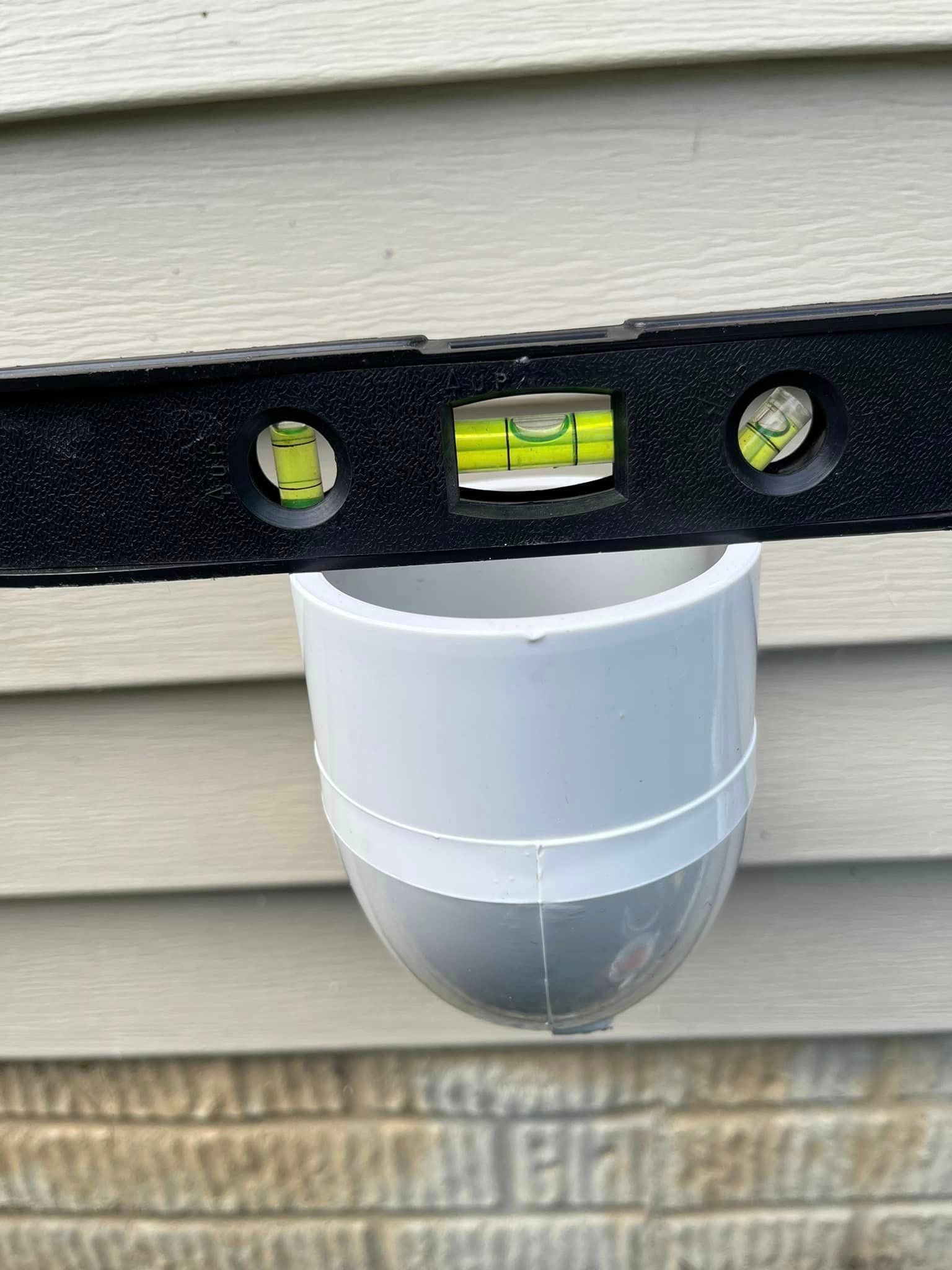 A level is being used to check the level of a pvc pipe.