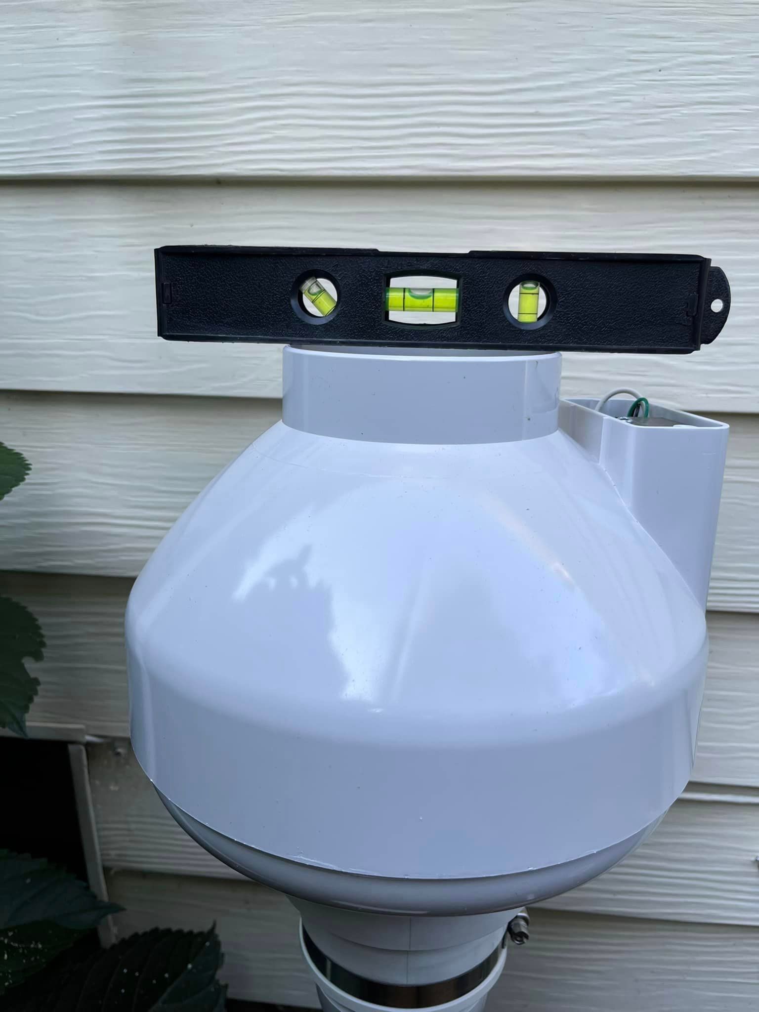 A black level is sitting on top of a white object.