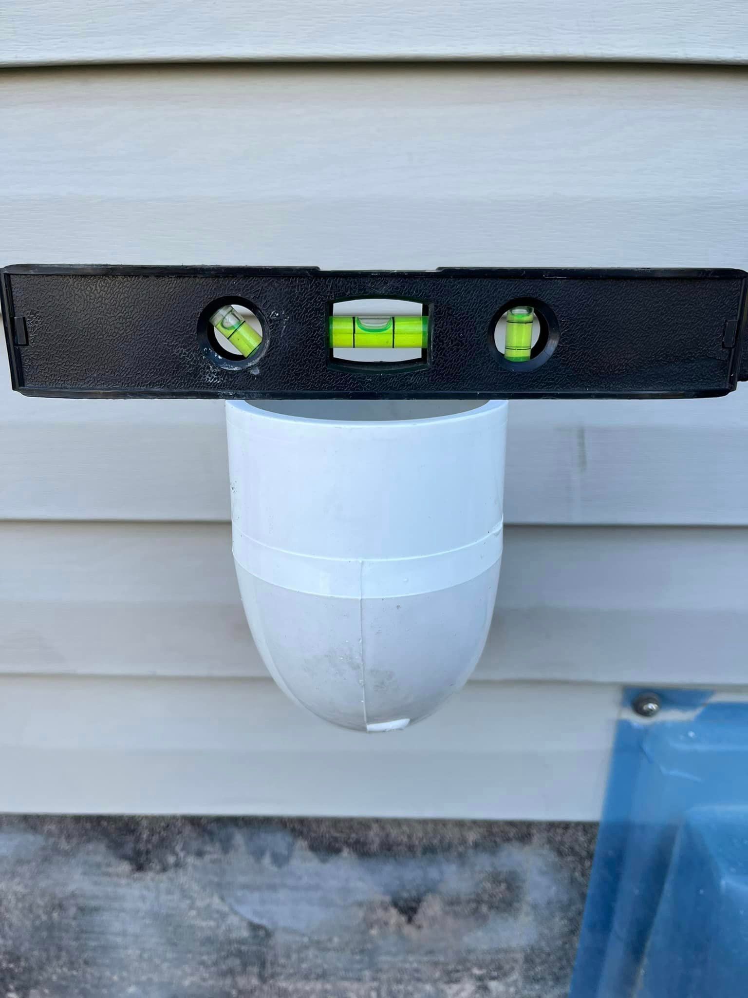 A level is being used to check the level of a pipe.