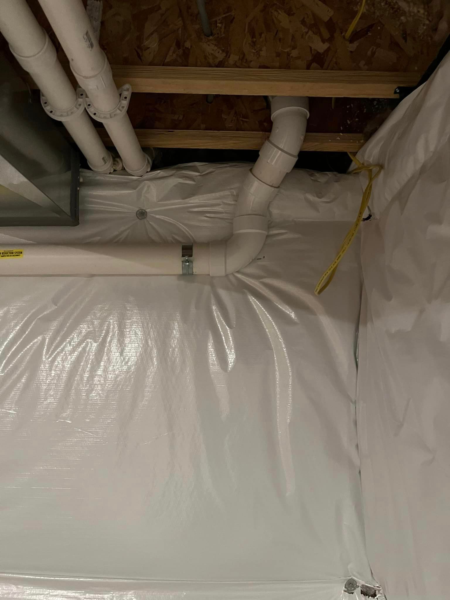 A room with a lot of pipes coming out of the ceiling.