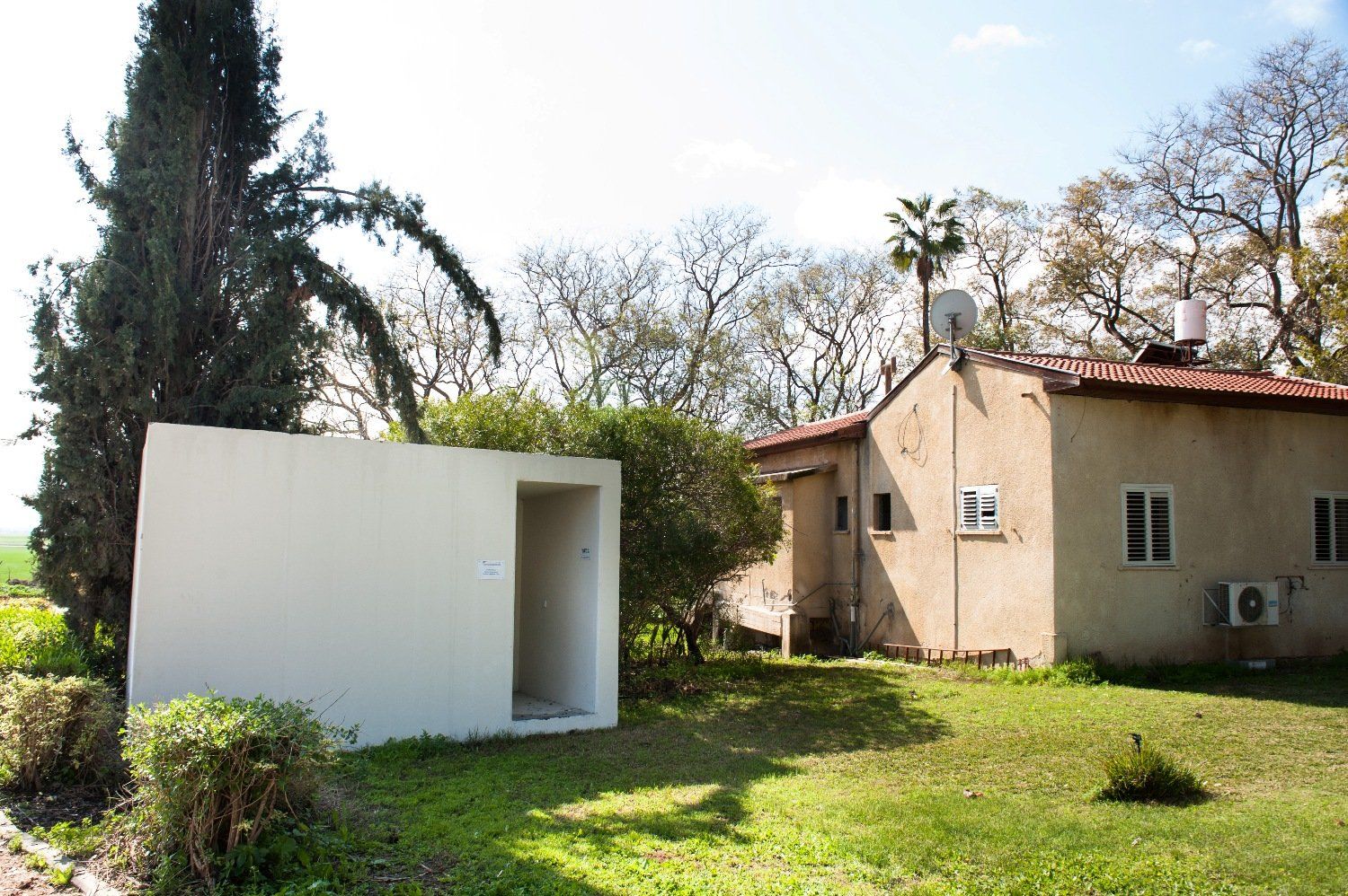 A house with a small white building in front of it