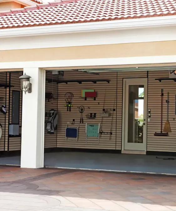 A garage with a slat wall and a glass door