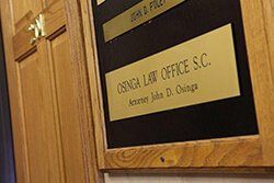 A wooden door with a sign on it that says o'bunga law office s.c.