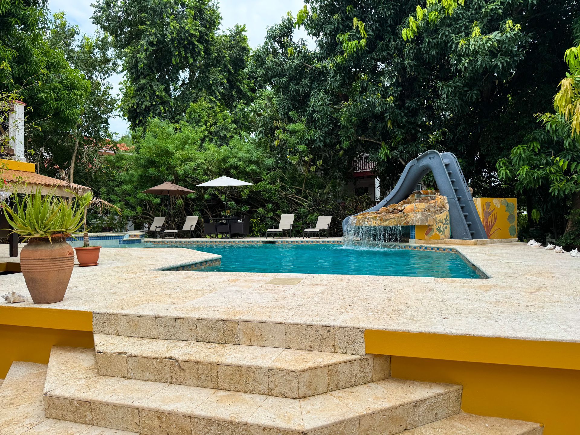 A large swimming pool with stairs leading up to it