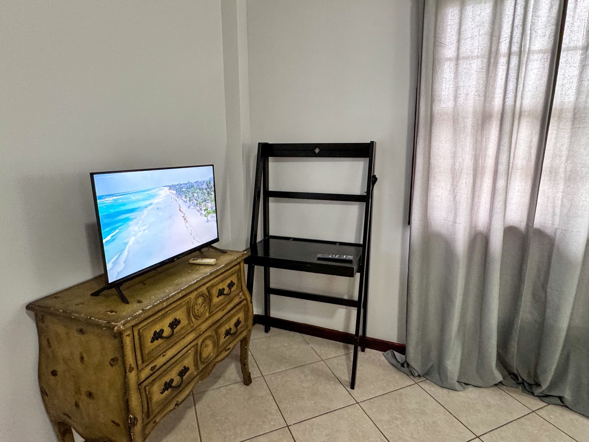 smart tv on a dresser at Caribbean Shores Bed and Breakfast Accommodation