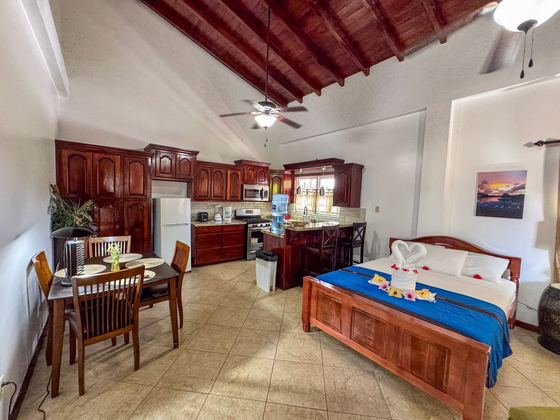 Cozy studio apartment in Hopkins Village with a queen bed in the middle of the room.