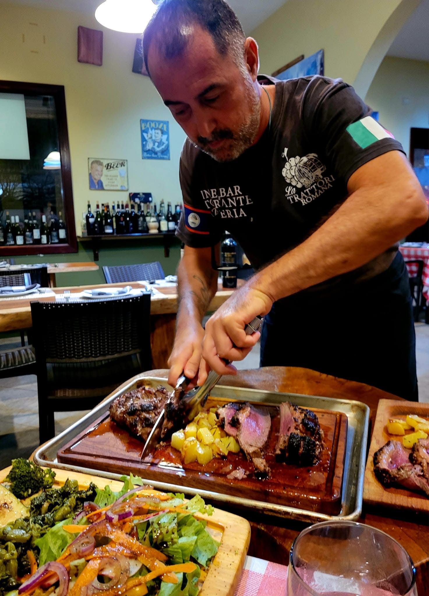 A man is cutting a piece of meat on a cutting board