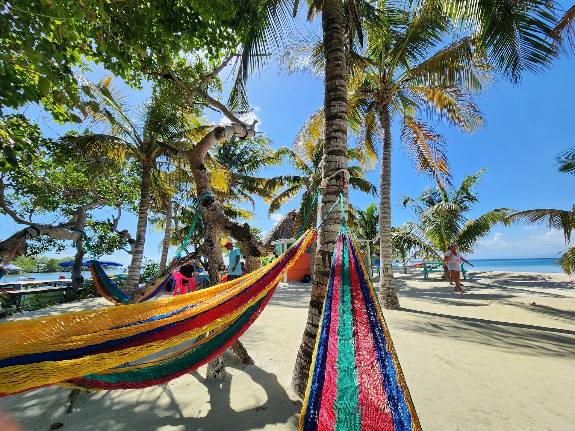 relaxing in the colorful hammock at Bread and butter Island, Island hopping tour from Hopkins Village Belize 