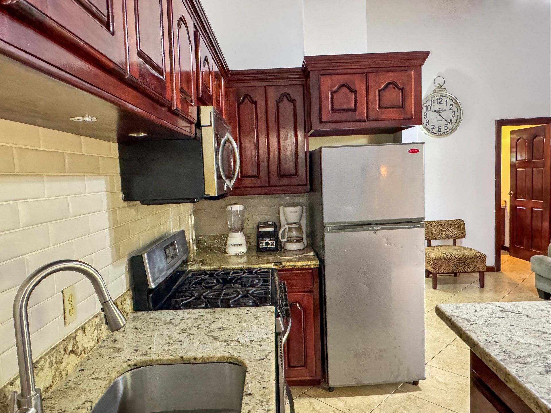 A kitchen with stainless steel appliances and granite counter tops