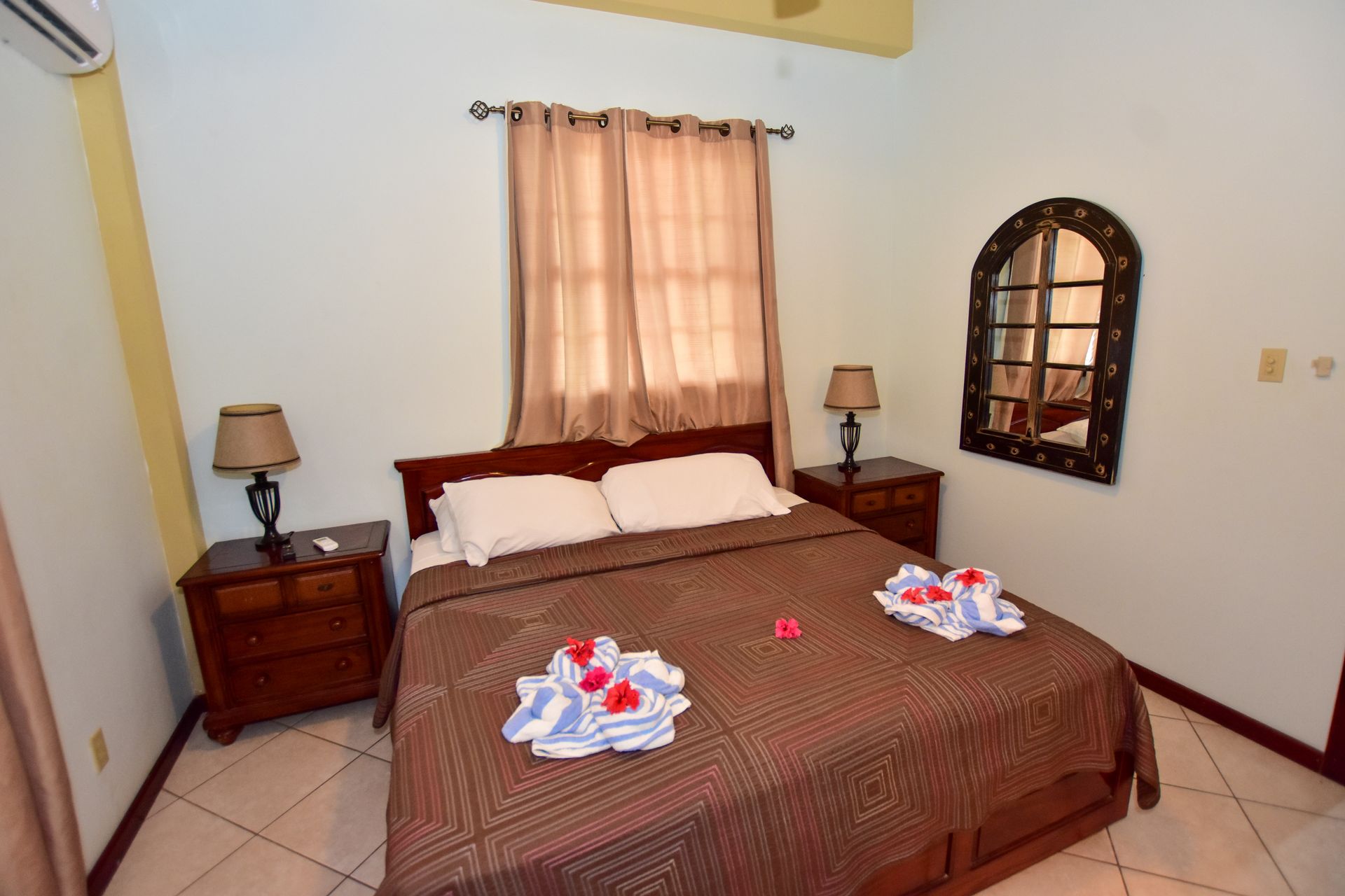 A bedroom with a king size bed and two nightstands