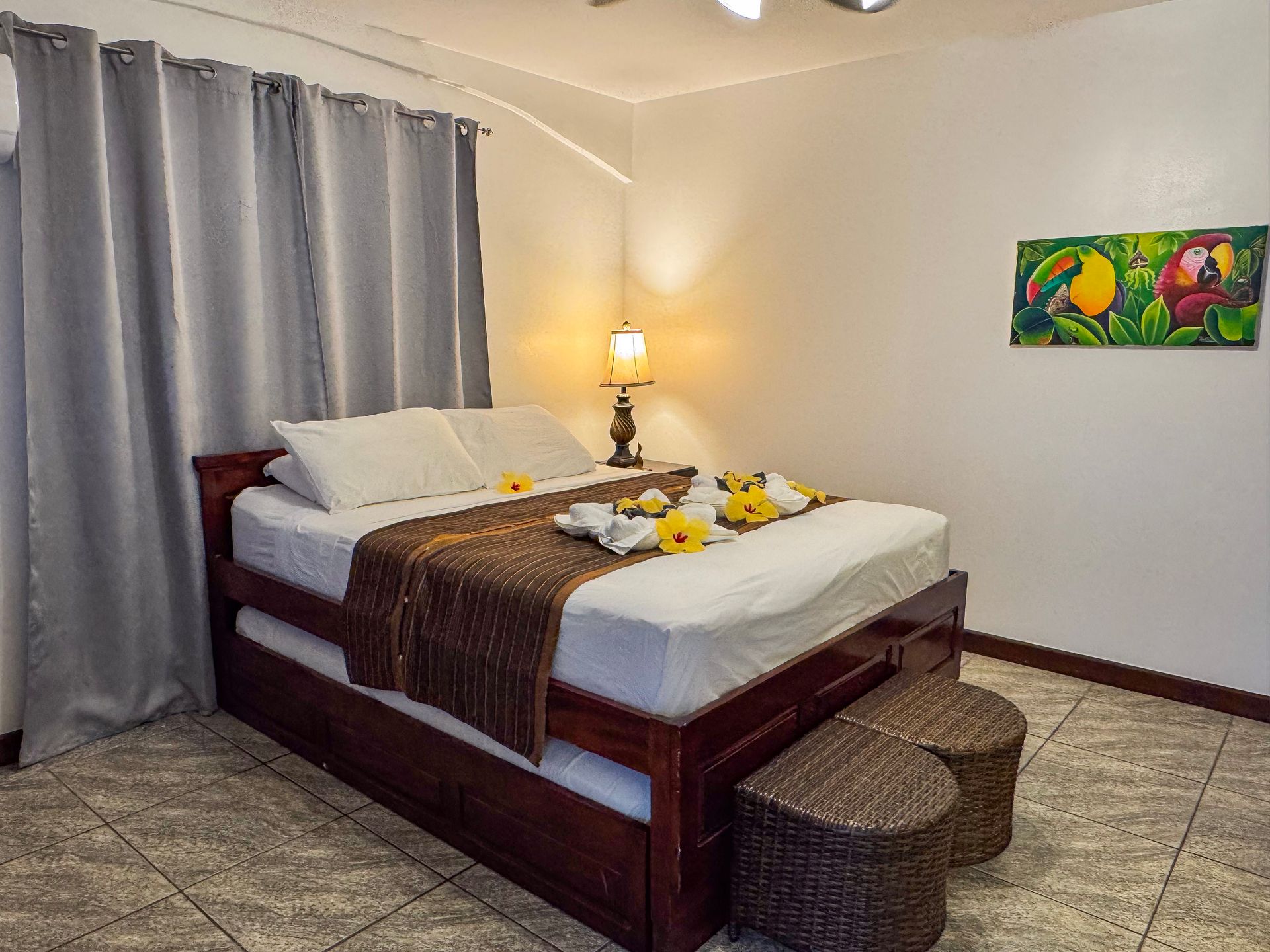 A bedroom with a king size bed and a painting on the wall.